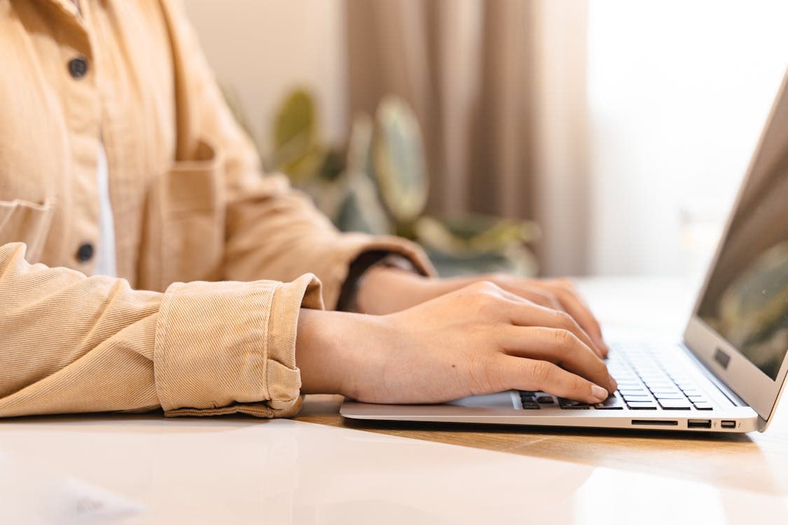 Person submitting a desk assembly request on a laptop