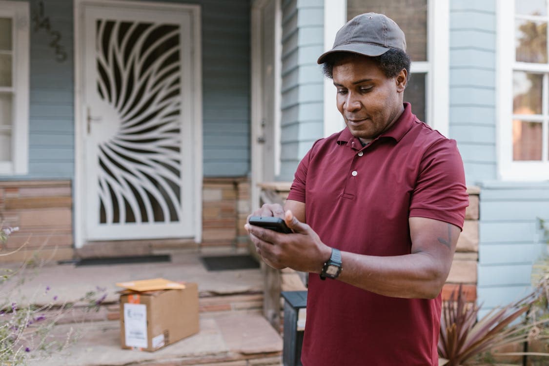 Customer confirming a handyman booking on smartphone outside their home