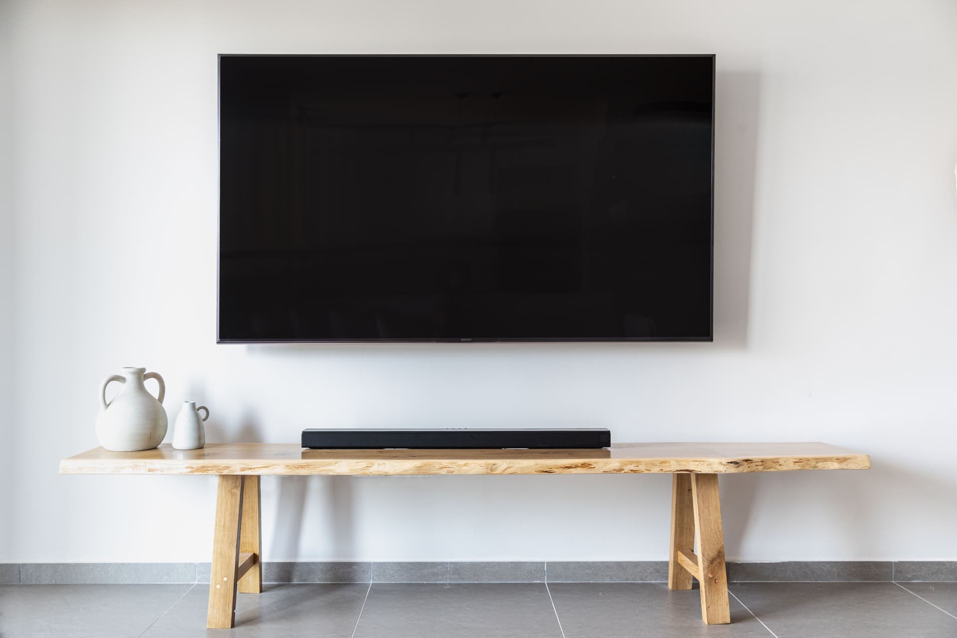 Professional installer wall-mounting a TV in a Ballarat home