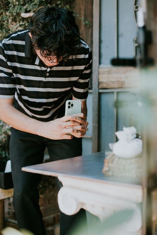 Man photographing items with smartphone to request a removal quote