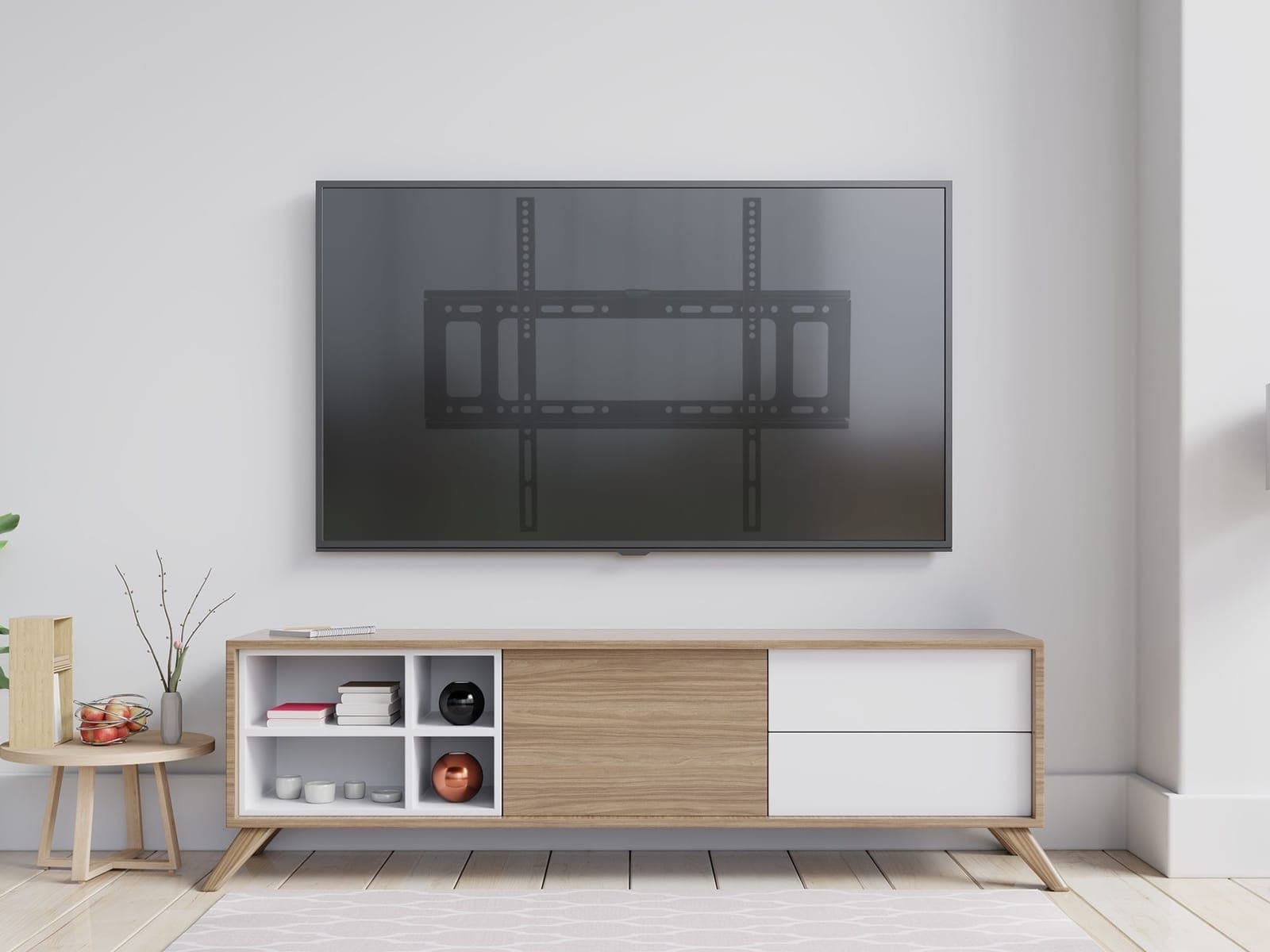 A wall mounted TV with the outline of its fixed bracket showing through the screen, above a timber and white sideboard